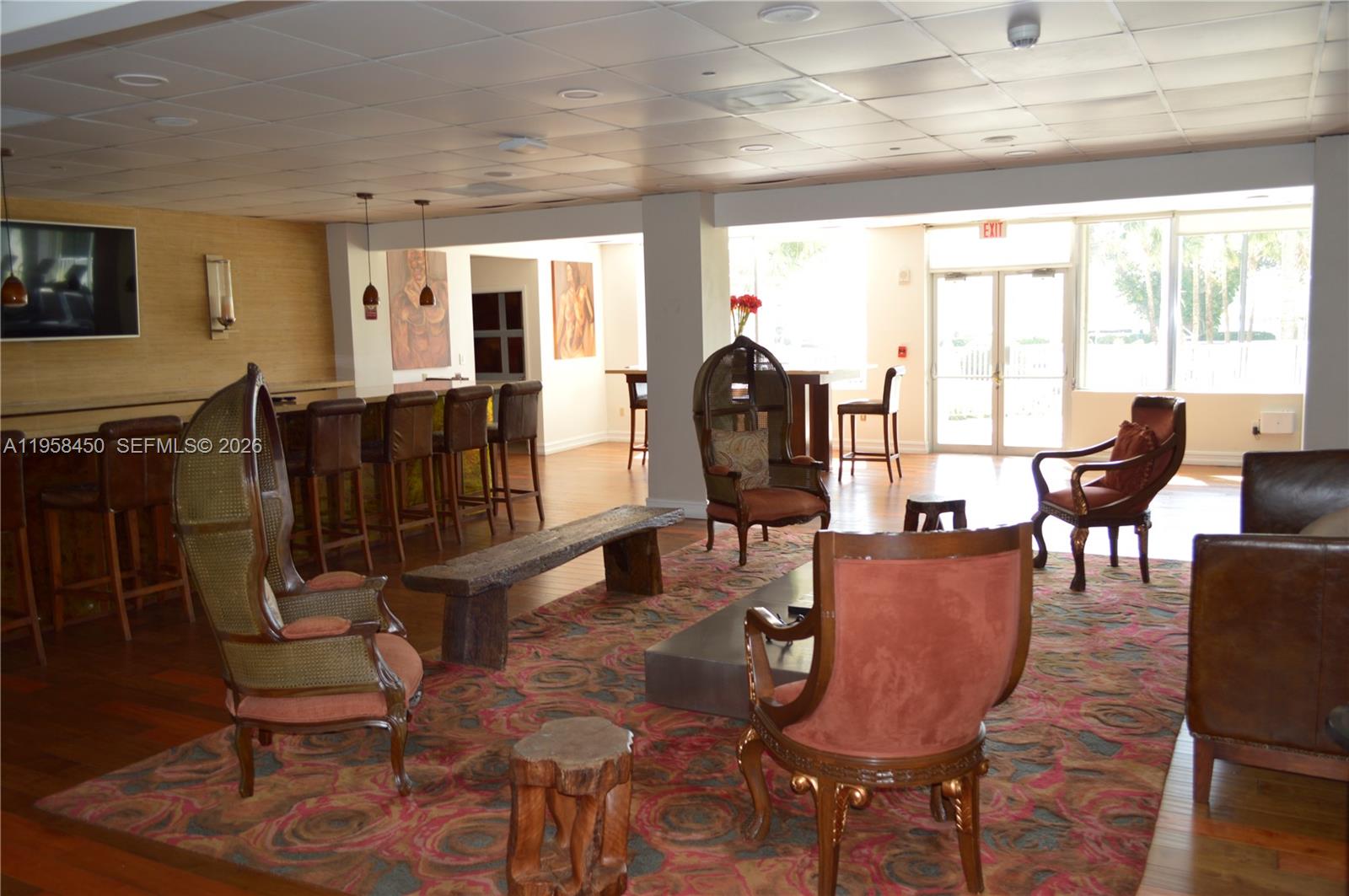 2451 Brickell Avenue, Unit PHM Miami, FL 33129 - Photo 8 of 52 a living room with furniture a flat screen tv and floor to ceiling window