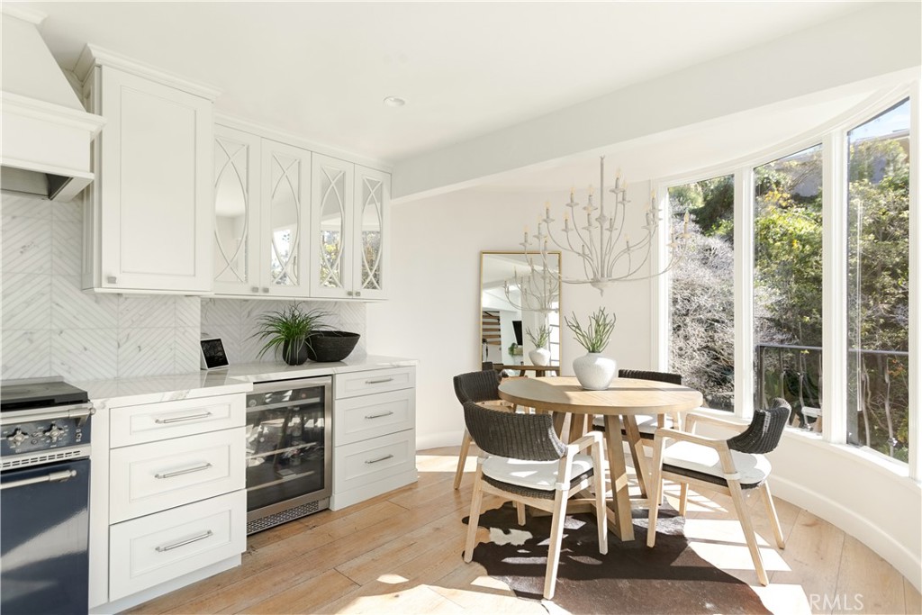 781 Summit Drive Laguna Beach, CA 92651 - Photo 24 of 73 a view of a dining room with furniture large windows and wooden floor