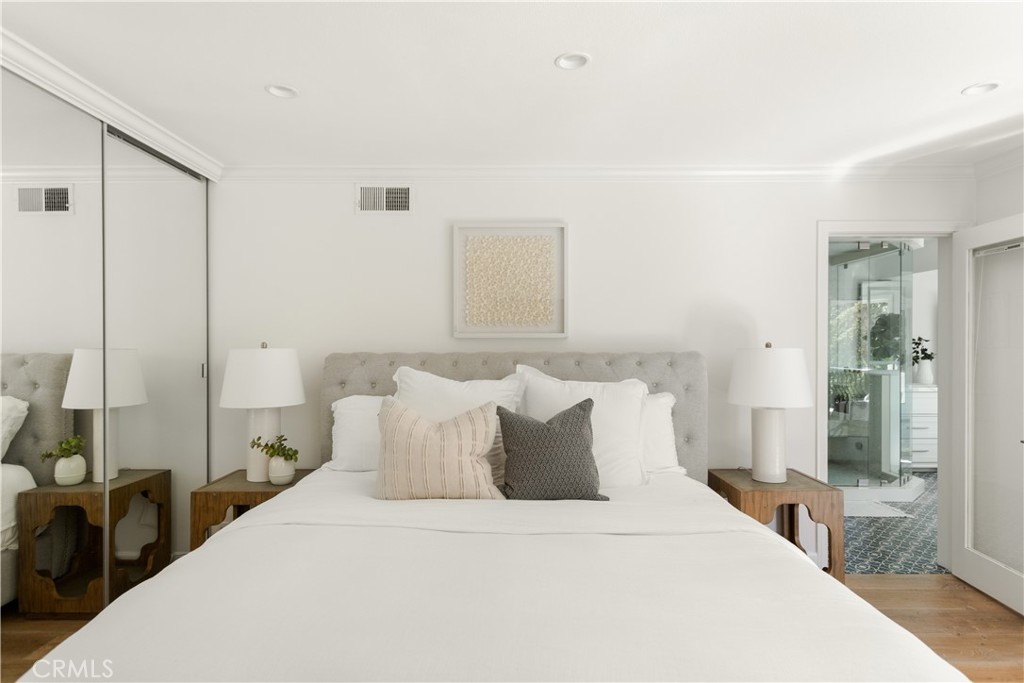 781 Summit Drive Laguna Beach, CA 92651 - Photo 38 of 73 a bedroom with a bed and a large mirror