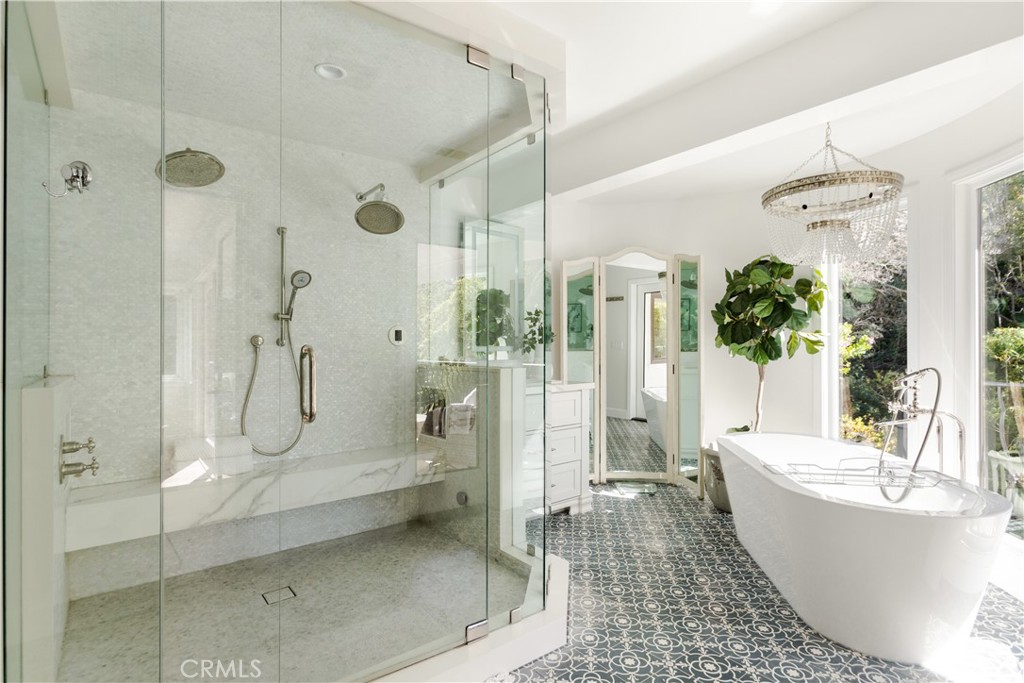 781 Summit Drive Laguna Beach, CA 92651 - Photo 41 of 73 a bathroom with a bathtub and a glass door shower