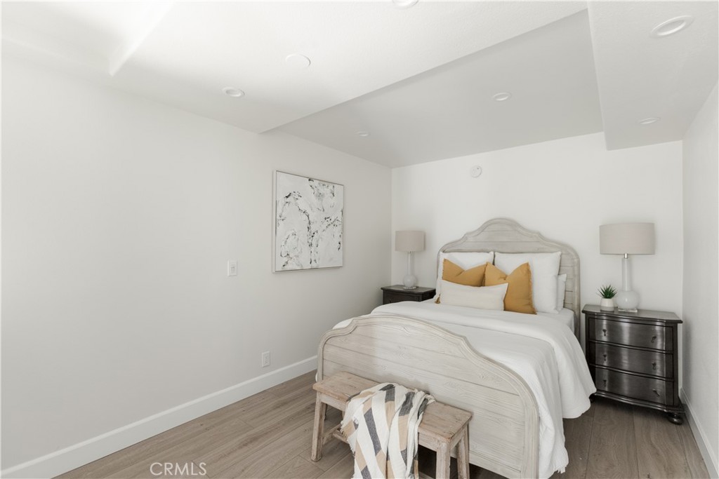 781 Summit Drive Laguna Beach, CA 92651 - Photo 58 of 73 a bedroom with a bed and wooden floor