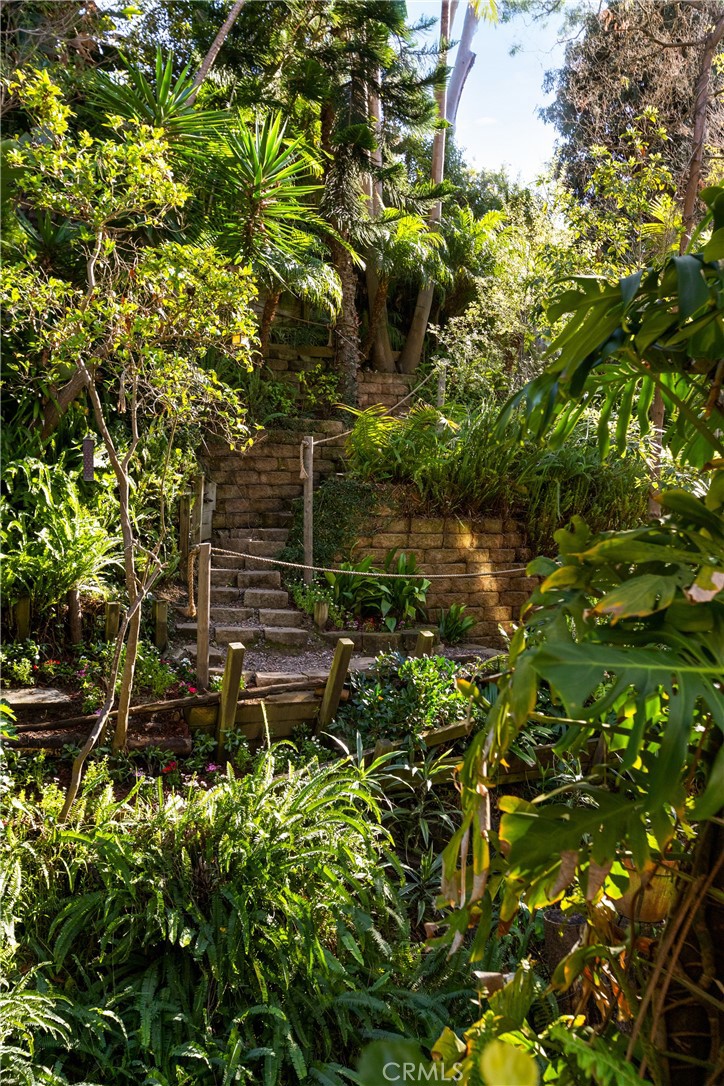 781 Summit Drive Laguna Beach, CA 92651 - Photo 64 of 73 a backyard of a building with lots of green space and fountain in middle