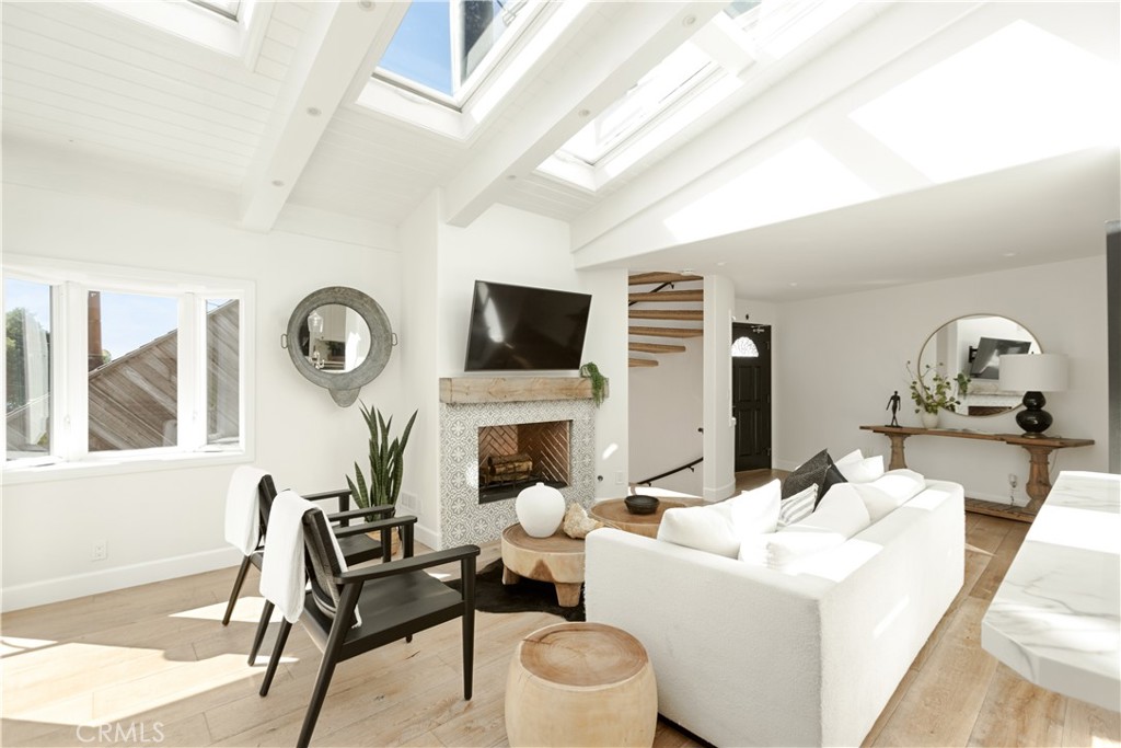 781 Summit Drive Laguna Beach, CA 92651 - Photo 10 of 73 a living room with furniture a fireplace and a large window