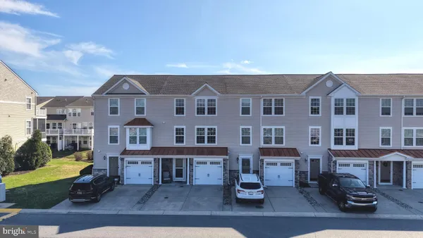an aerial view of residential houses with yard