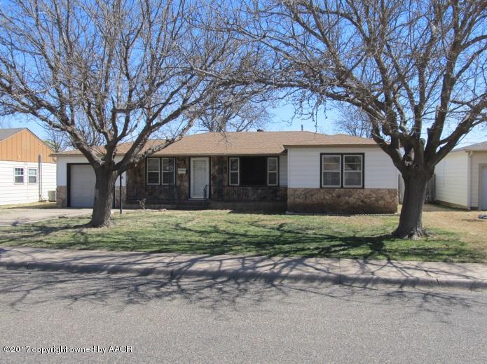 4305 South Travis Street Amarillo, TX 79110 - Photo 2 of 15 a view of a house with a yard and large tree