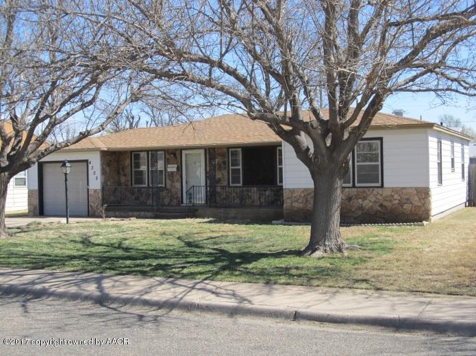 4305 South Travis Street Amarillo, TX 79110 - Photo 3 of 15 a white house that has a tree in front of a house