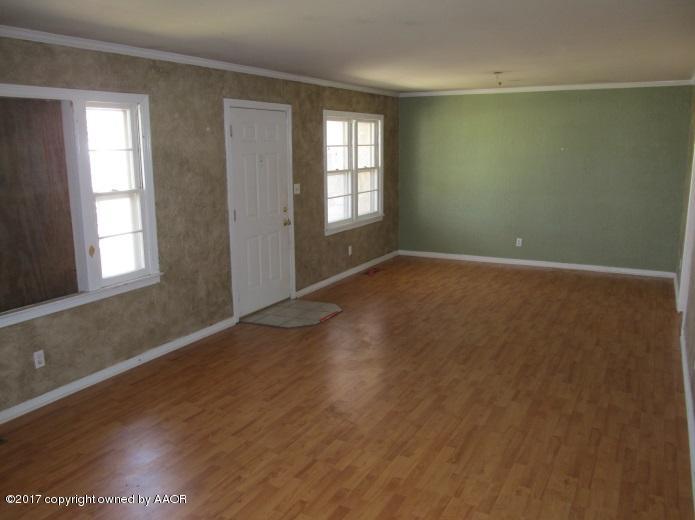 4305 South Travis Street Amarillo, TX 79110 - Photo 5 of 15 an empty room with wooden floor and windows