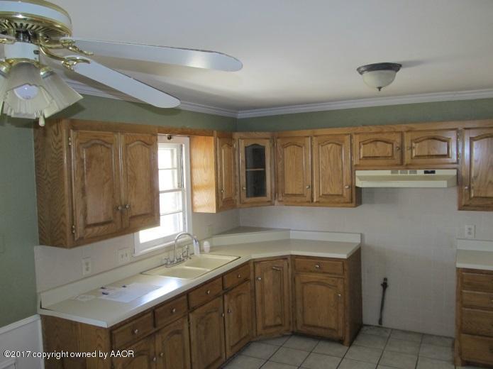 4305 South Travis Street Amarillo, TX 79110 - Photo 6 of 15 a kitchen with cabinets appliances and a sink