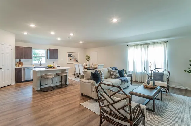 a living room with furniture kitchen view and a table