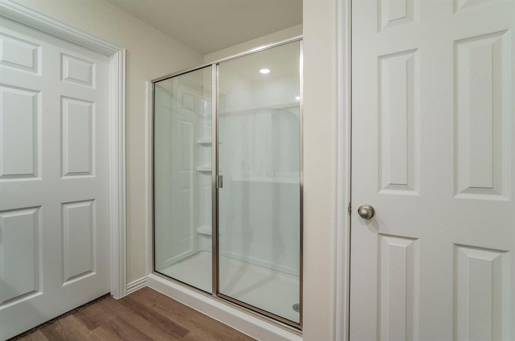 440 Rose Avenue Cleburne, TX 76033 - Photo 9 of 14 a bathroom with a glass shower door