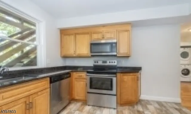 a kitchen with stainless steel appliances a stove a microwave sink and cabinets
