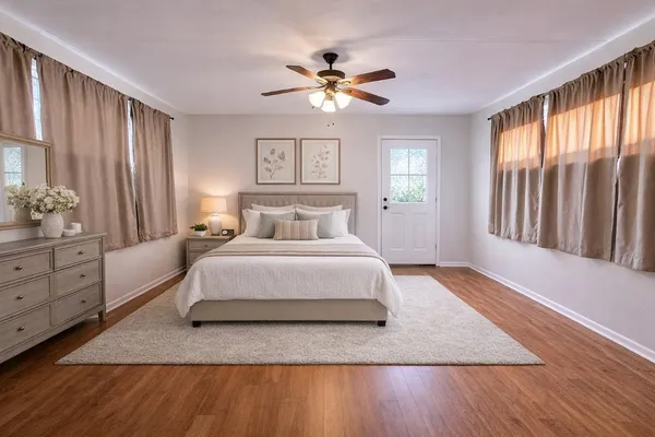 a spacious bedroom with a large bed and a window