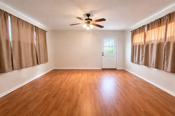 wooden floor in an empty room with a window