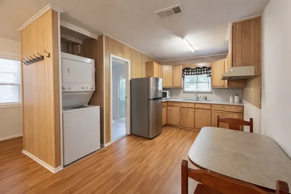 a kitchen with a refrigerator a sink and cabinets