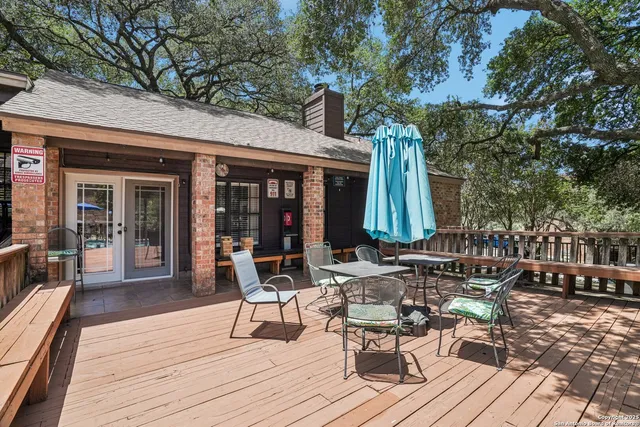 a view of a dinning tables and chairs in patio with a barbeque grill