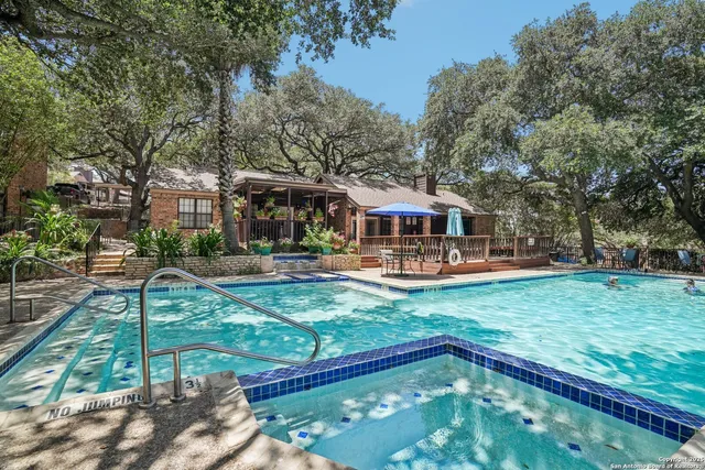 a view of a house with swimming pool and a yard