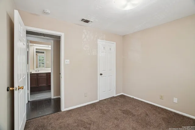 a view of an empty room and fire place