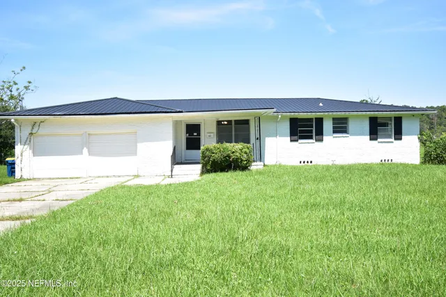 a front view of house with yard and green space