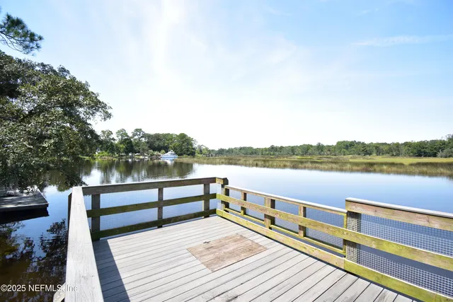 a view of a lake with houses in the background