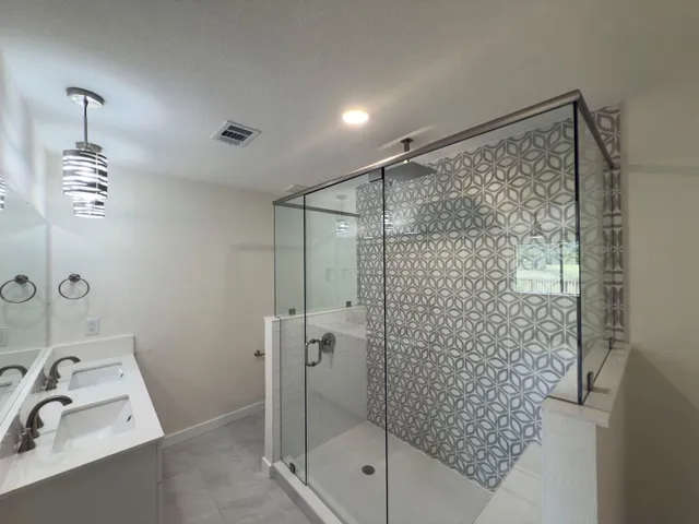 a bathroom with a shower and a sink