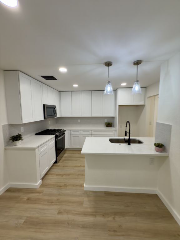 818 Russet Valley Drive Cedar Park, TX 78613 - Photo 4 of 17 a large kitchen with kitchen island a sink stainless steel appliances and cabinets