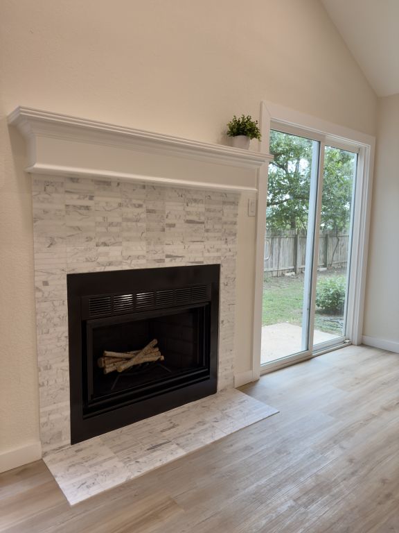 818 Russet Valley Drive Cedar Park, TX 78613 - Photo 8 of 17 Detailed view of a fireplace with flush hearth and wood finished floors
