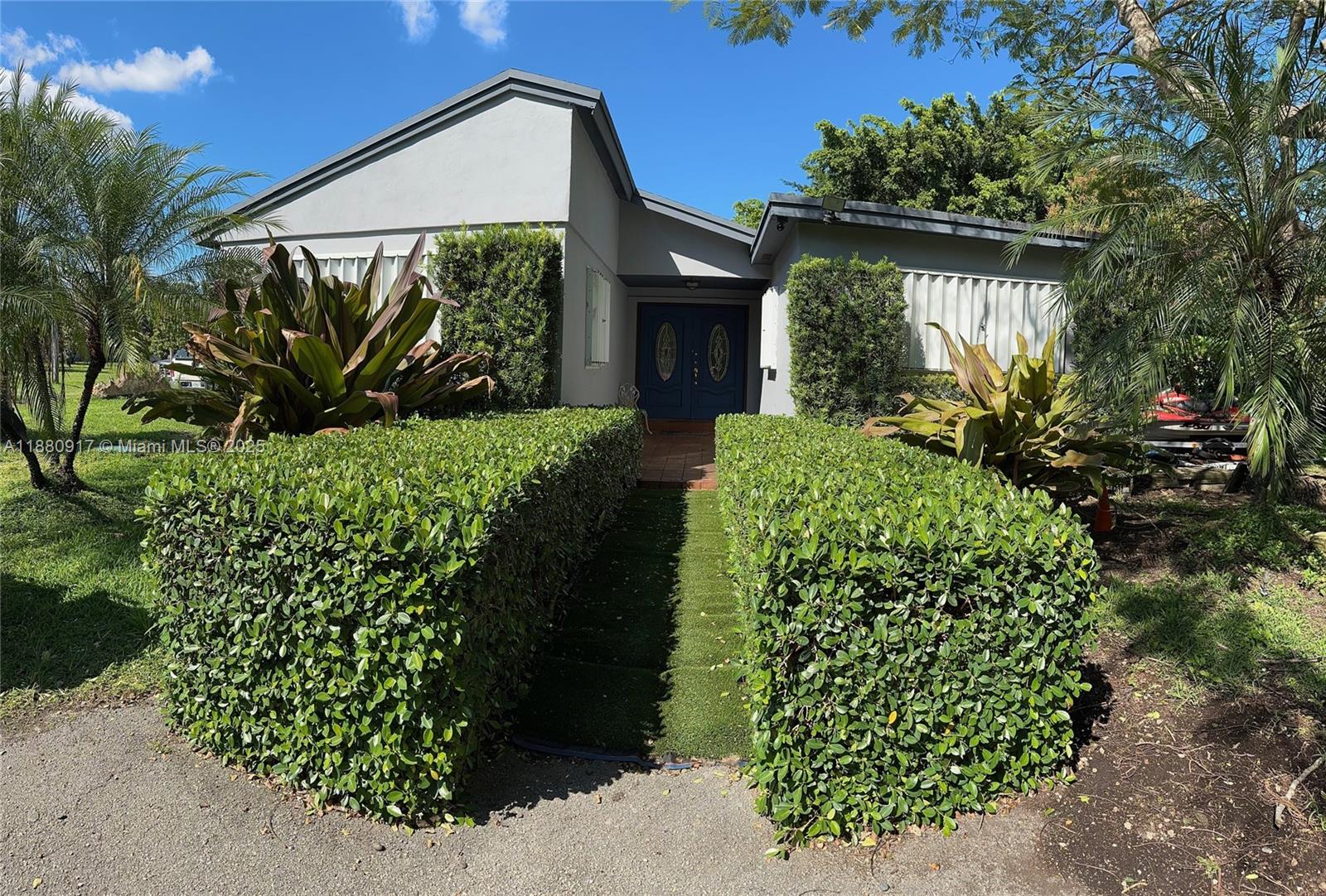 12495 Southwest 240th Street Homestead, FL 33032 - Photo 1 of 26 a front view of a house with garden