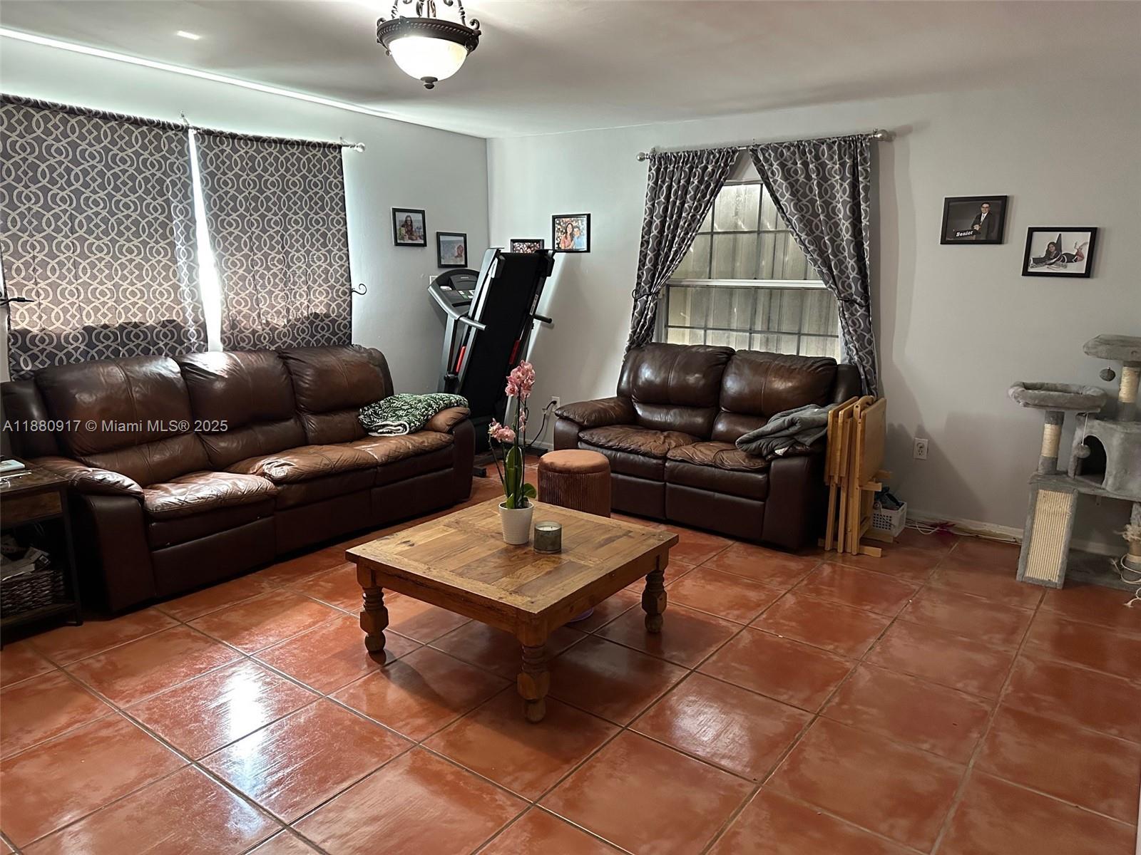 12495 Southwest 240th Street Homestead, FL 33032 - Photo 13 of 26 a living room with furniture and a flat screen tv