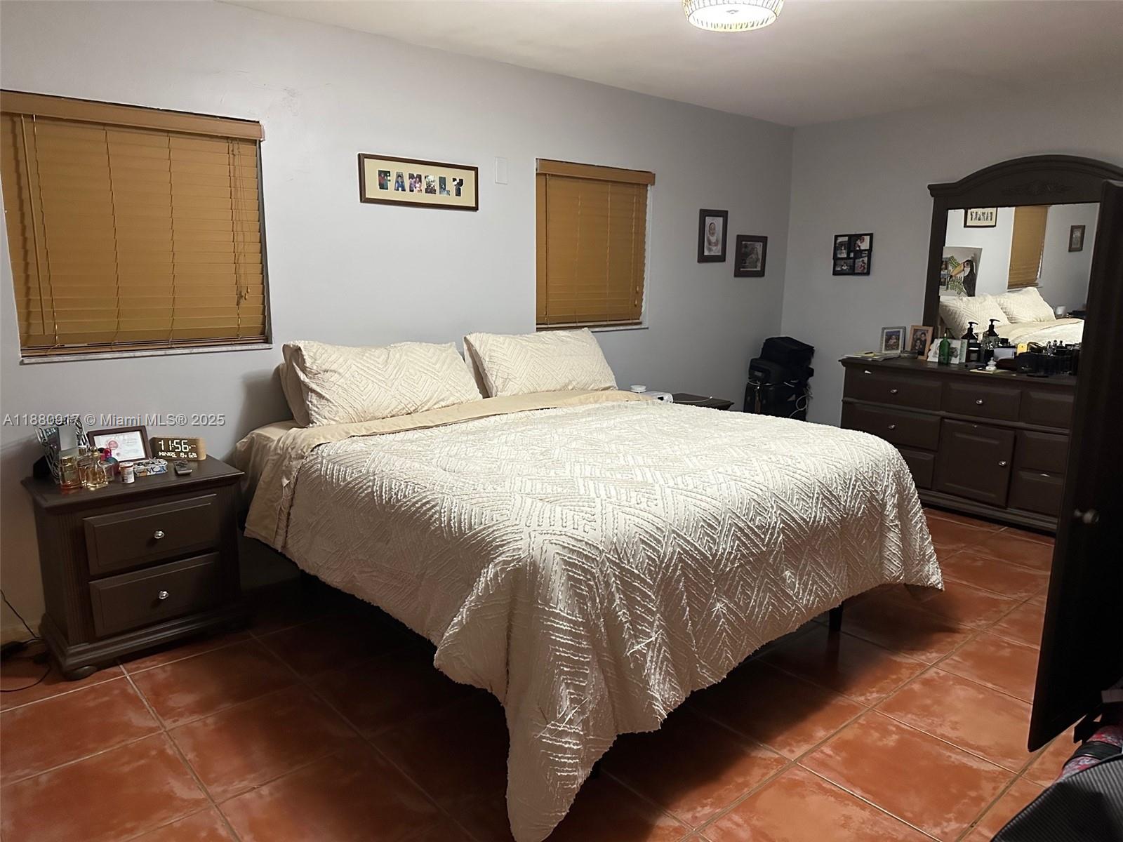 12495 Southwest 240th Street Homestead, FL 33032 - Photo 15 of 26 a bedroom with a bed and a lamp on dresser