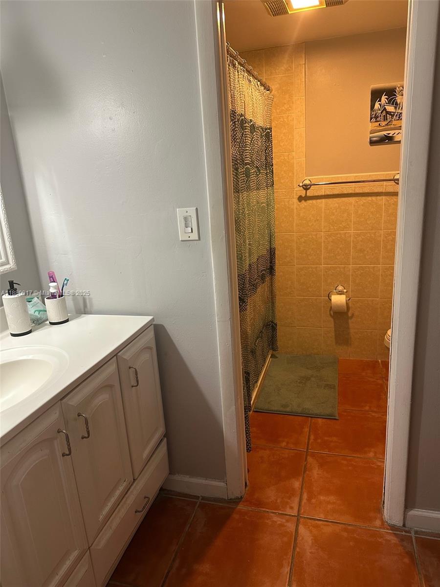 12495 Southwest 240th Street Homestead, FL 33032 - Photo 16 of 26 a bathroom with a sink and a mirror