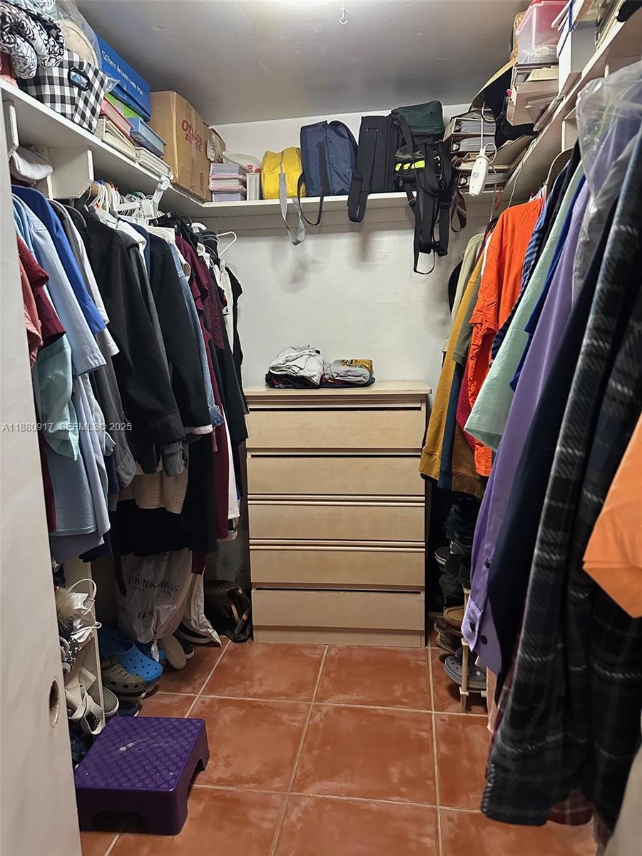 12495 Southwest 240th Street Homestead, FL 33032 - Photo 17 of 26 a view of walk in closet with clothes and shoes