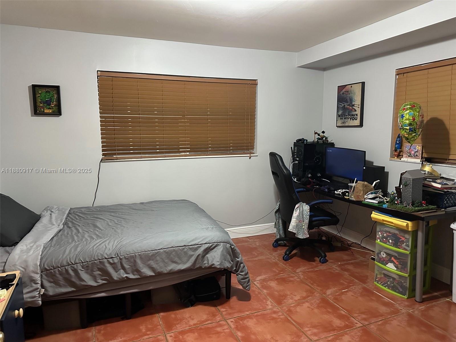 12495 Southwest 240th Street Homestead, FL 33032 - Photo 18 of 26 a bedroom with a bed and a desk