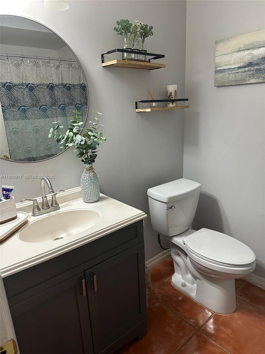 12495 Southwest 240th Street Homestead, FL 33032 - Photo 21 of 26 a bathroom with a sink toilet and a mirror