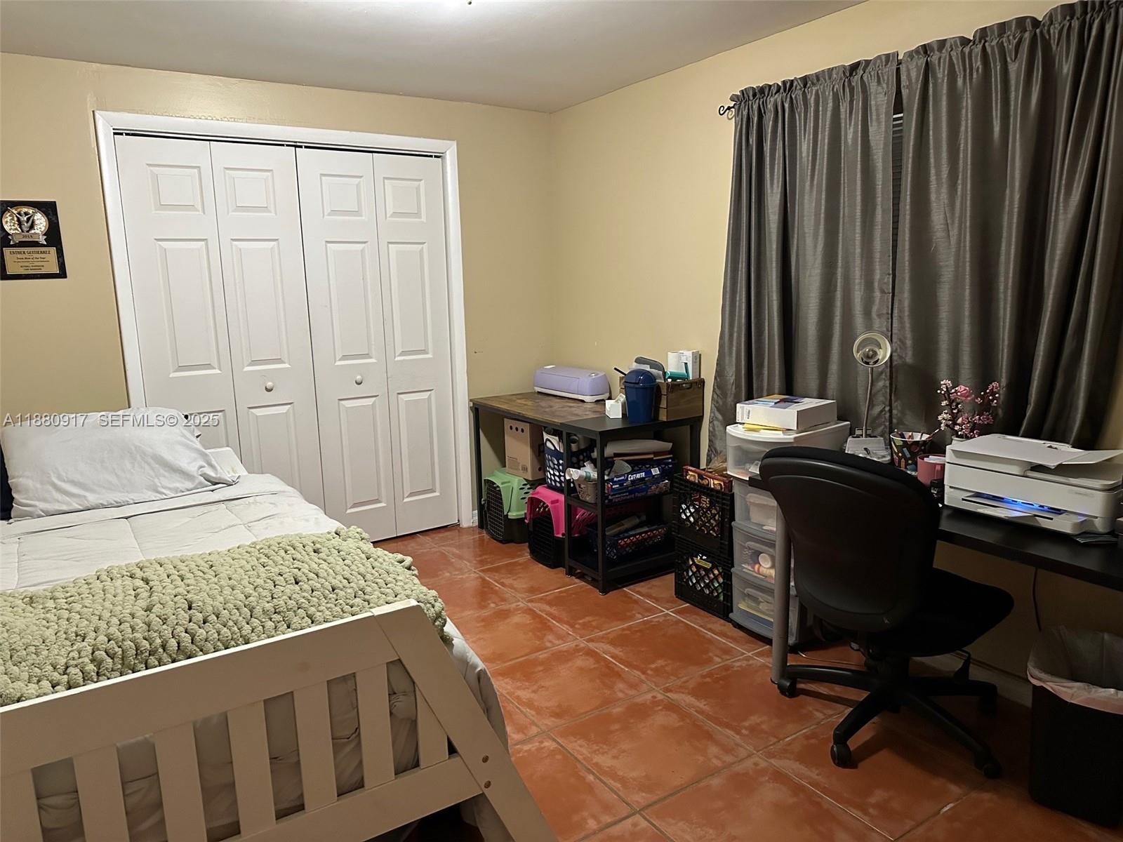 12495 Southwest 240th Street Homestead, FL 33032 - Photo 22 of 26 a bedroom with a bed and a desk