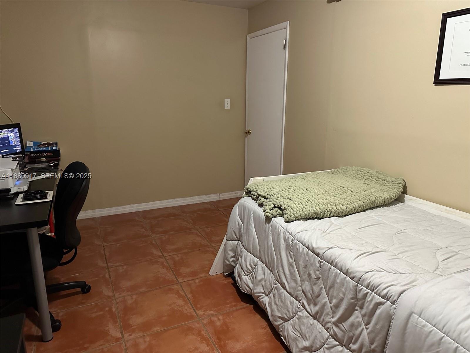 12495 Southwest 240th Street Homestead, FL 33032 - Photo 23 of 26 a bedroom with a bed chair and a desk