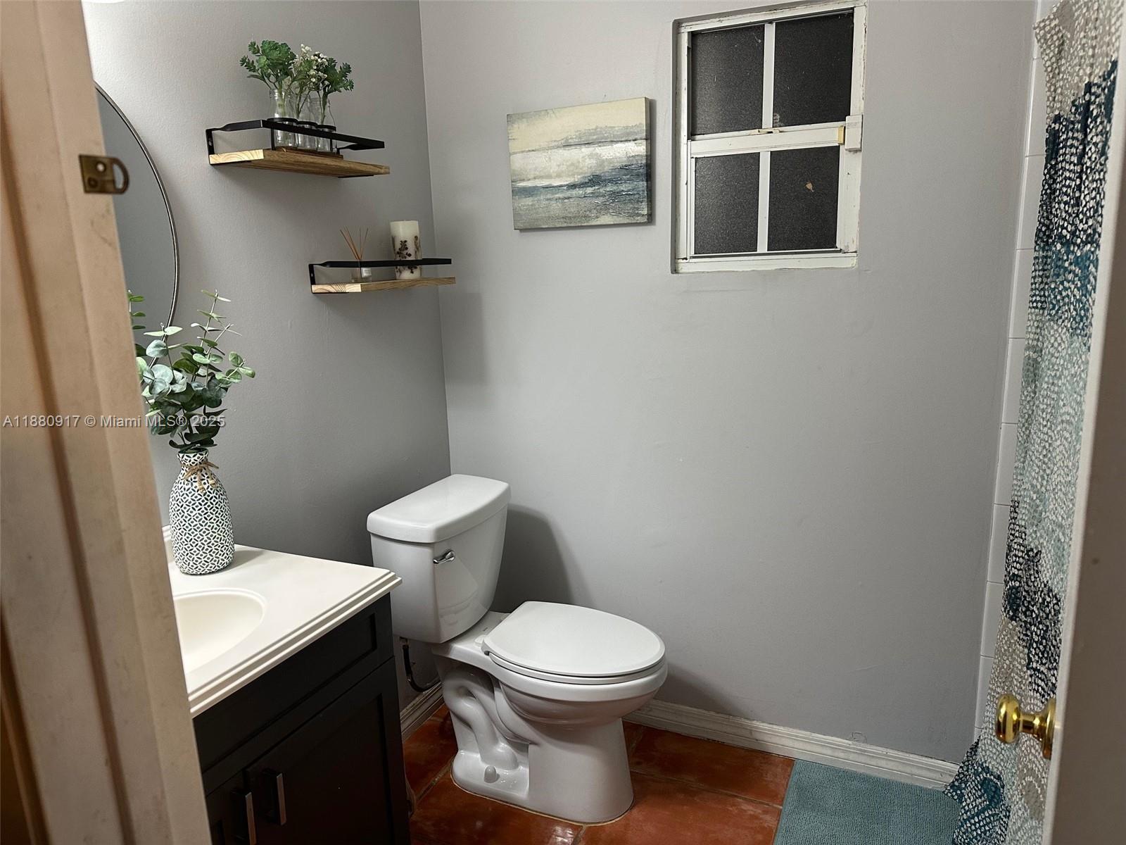 12495 Southwest 240th Street Homestead, FL 33032 - Photo 24 of 26 a white toilet sitting next to a bathroom sink