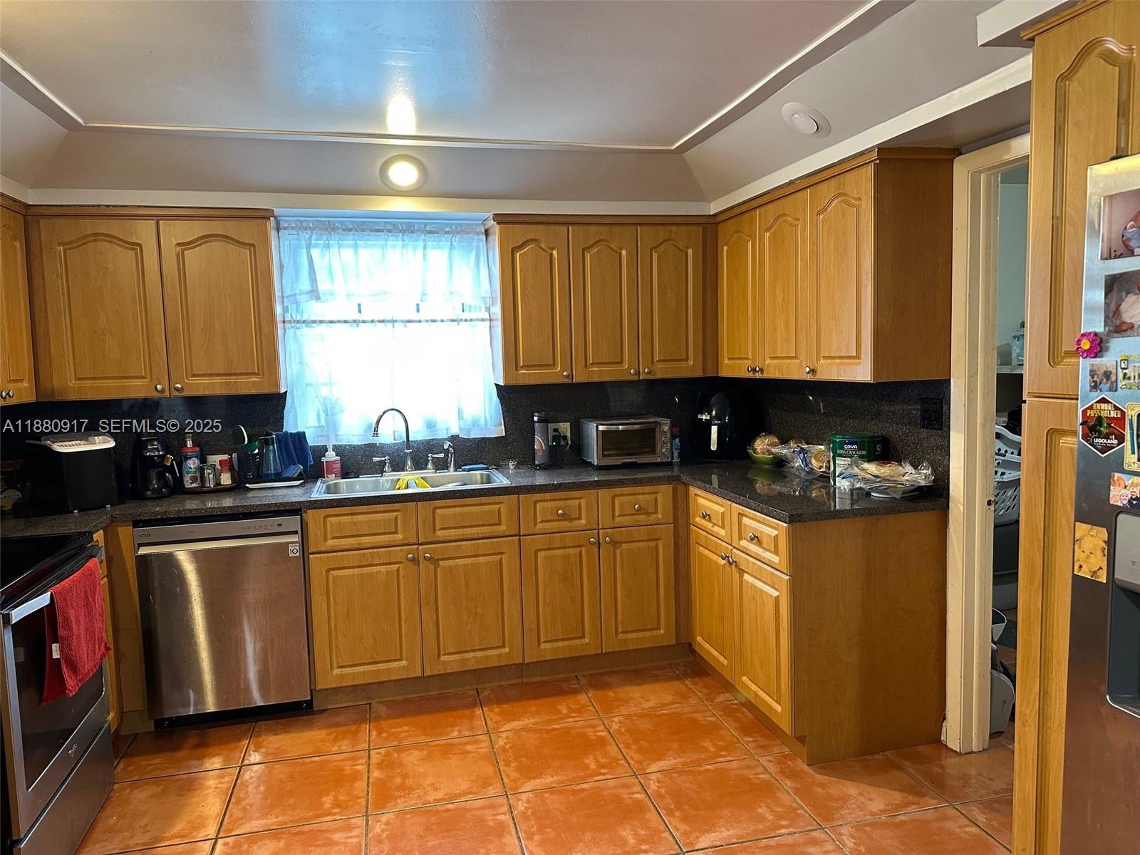 12495 Southwest 240th Street Homestead, FL 33032 - Photo 8 of 26 a kitchen with stainless steel appliances granite countertop sink stove and cabinets