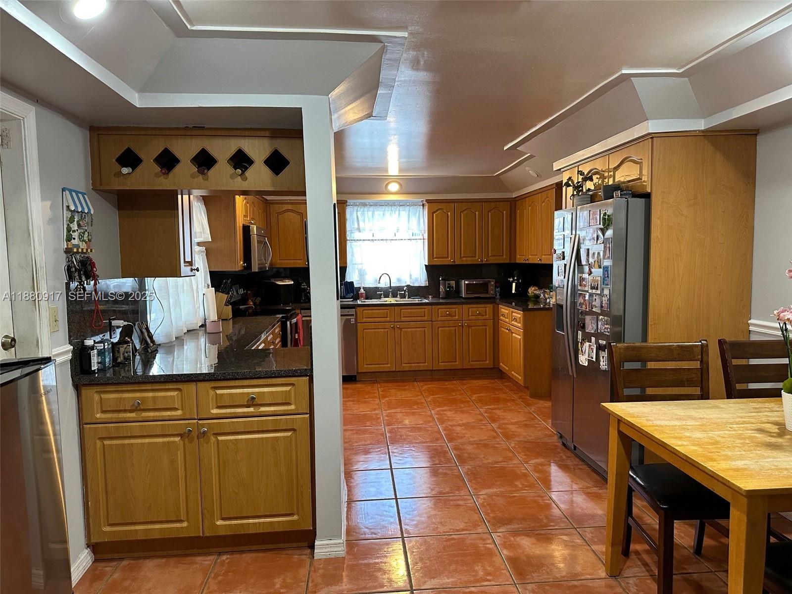 12495 Southwest 240th Street Homestead, FL 33032 - Photo 10 of 26 a kitchen with stainless steel appliances granite countertop a stove a sink and a refrigerator