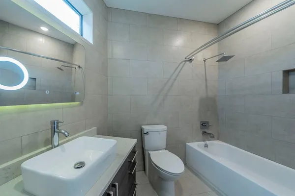 a bathroom with a sink toilet and shower