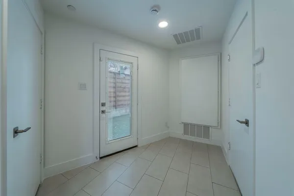 a front view of a house with a garden and plants