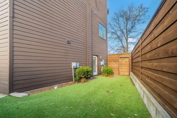 a view of backyard with garden and deck