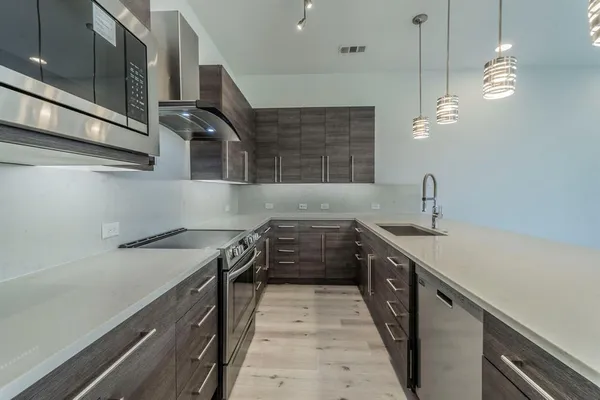 a kitchen with a sink and a stove top oven