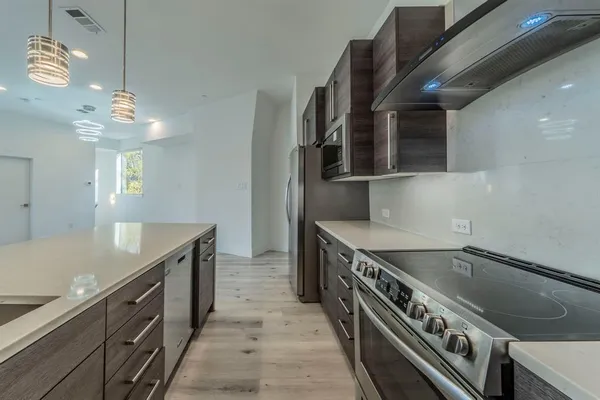 a kitchen with a stove and a sink