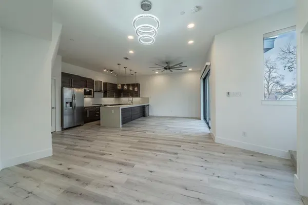 a view of a kitchen with a sink and stainless steel appliances