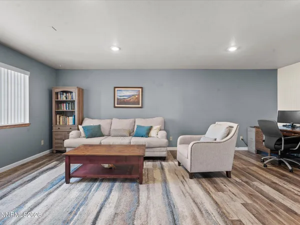 a kitchen with stainless steel appliances kitchen island granite countertop a table chairs sink and cabinets