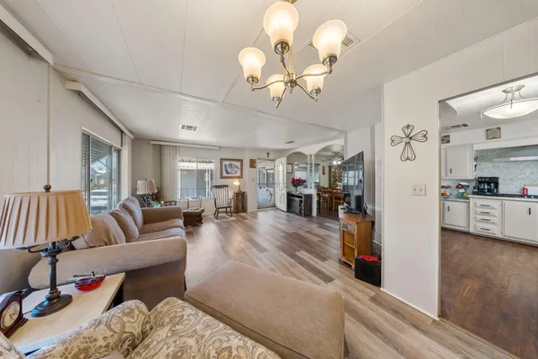 a kitchen with a dining table cabinets stainless steel appliances and dining table