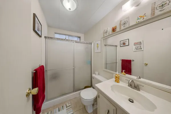 a bedroom with bed and a large mirror