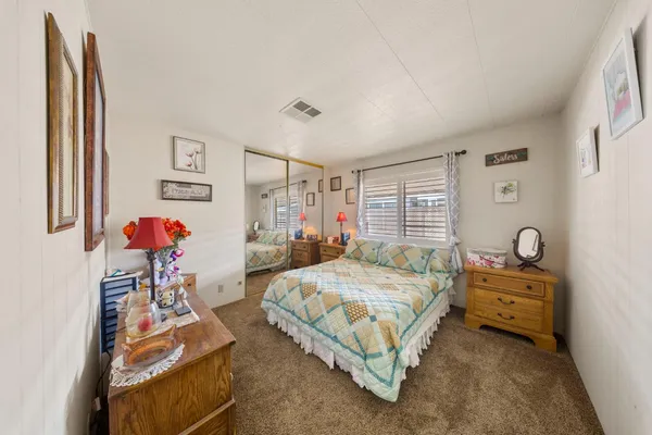 a bedroom with a bed and a couch