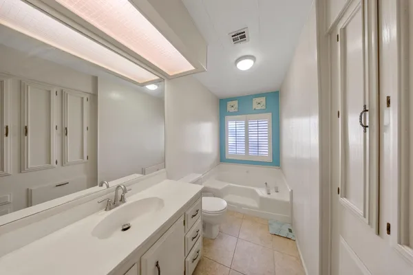 a bedroom with furniture and windows