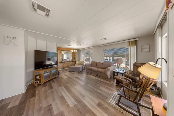 a living room with furniture and wooden floor